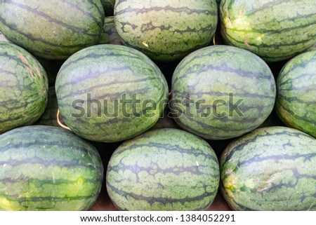 watermelons were stocked in horizontal layers to show their nature pattern texture that was colorful in market. It gave many thing refreshment, vitamin nutrition and juicy tasty for healthy people