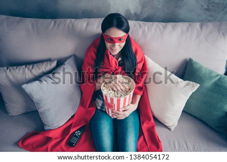 High angle top above photo beautiful she her superpower lady costume hold popcorn container watch premiere new long wait comics picture wear red eye mask mantle sit sofa couch divan house indoors
