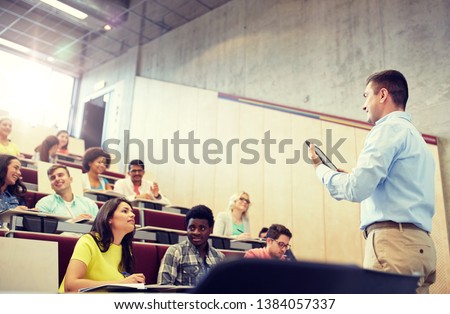 education, high school, university, teaching and people concept - group of international students and teacher with tablet pc computer standing at white board at lecture