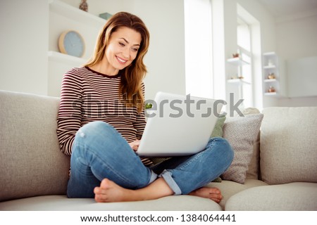 Close up photo beautiful she her lady hands arms hold notebook speak tell talk say skype relatives friends wear jeans denim striped pullover clothes sit comfort cosy divan house living room indoors