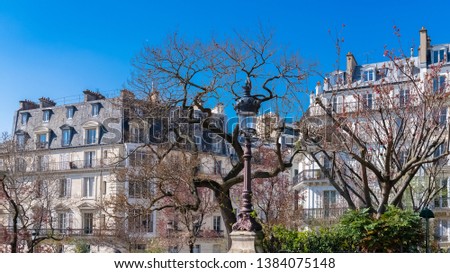 Paris, place franz-Liszt, charmant square and beautiful buildings in spring, with cherry trees
