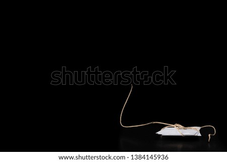 White envelope tied with a rope lies on a black background