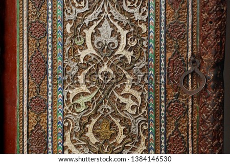 Masterpiece of wood carving with inlay, details and elements of antique doors in Samarkand, Uzbekistan                               
