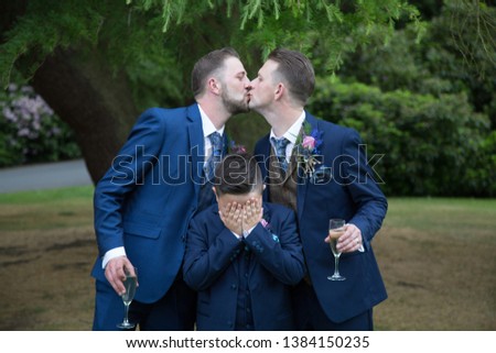 Two gay men on wedding day having a kiss 
