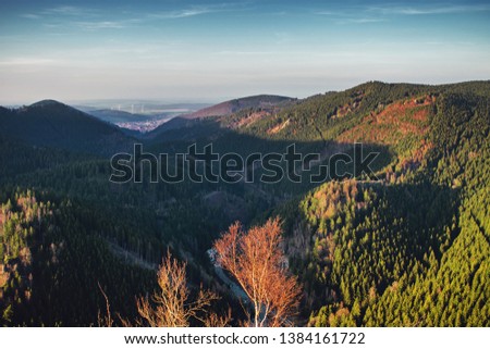 Valley view from the mountain top down at sunset time.  National Park Harz Mountains in Germany