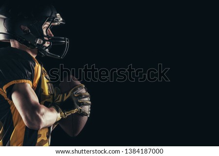 American football player isolated on black background