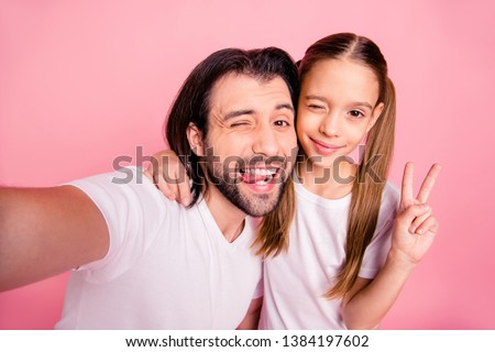Close up photo she her little lady he him his single dad daddy make take selfies blink eyes show v-sign shooting tongue out mouth wear casual white t-shirts denim jeans isolated pink bright background