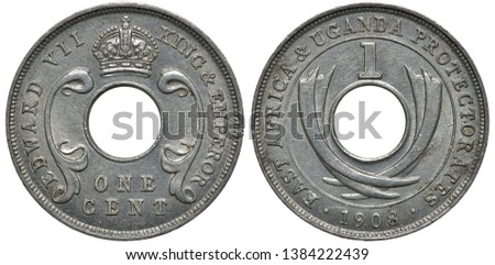 British East Africa and Uganda Protectorates aluminum coin 1 one cent 1908, title of Emperor Edward VII around central hole, crown on top, crossed tusks, denomination above,  Royalty-Free Stock Photo #1384222439
