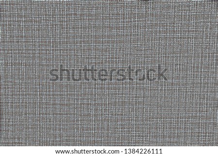 Fabric texture with intertwined gray, white and brown threads. Beautiful tissue texture for design. The background fabric with the filaments randomly intertwined.