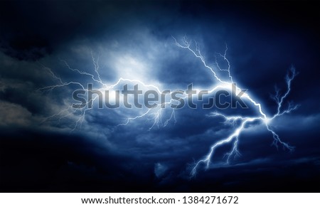 Lightning strike on the cloudy dark sky.