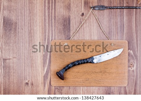 Wooden signboard with knife hanging planks background