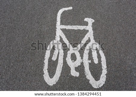 White painted bicycle crossing on pavement