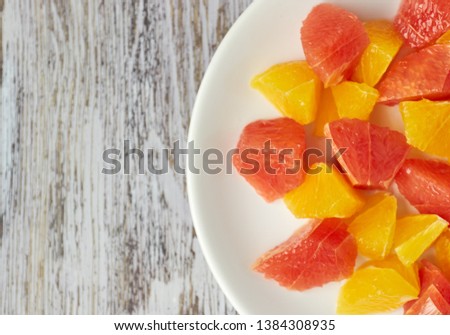 Orange-grapefruit citrus salad on a shabby wooden table. copy space. summer vitamin salad.