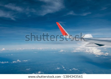 red winglet in graduated dark blue sky  Royalty-Free Stock Photo #1384343561