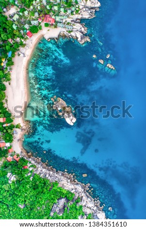 Tanote Bay, Koh Tao with corals and sandy beach deep blue sea and reefs visible top down view birdseye Thailand