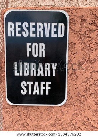 Reserved for Library Staff sign on side of library building
