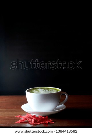Autumn Leaves, Matcha green tea latte hot drink placing on the brown rustic wooden table, with natural light, food dark photography
