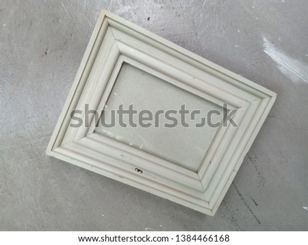 Background picture frame made of white wood hanging on the wall
