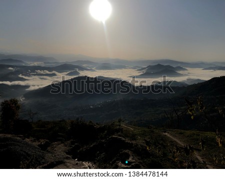 Low light photography hills above clouds