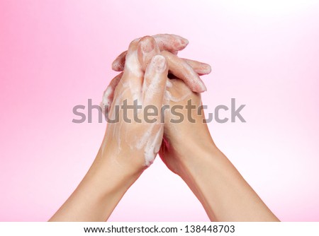Hands and foam on a pink background  
