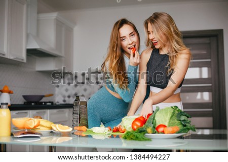Two sports girls. Woman with vegetables. Lady in a sport clothes