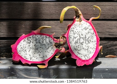dragon fruits on sackcloth and brown wooden background - images
