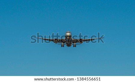 Aeroplane Photographed From Below at landing,  bottom view of the belly with the power train.