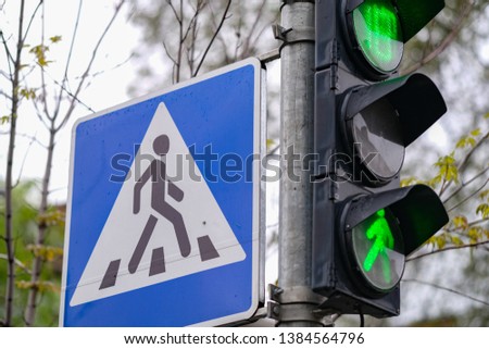 traffic lights. green color and pedestrian crossing sign in a city.
