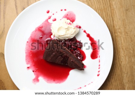  Brownie with raspberry sauce and ice cream.