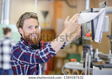 portrait of young man working at modern factory Royalty-Free Stock Photo #1384587632