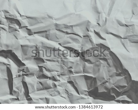 Surface of wrinkled paper texture background, black and white.