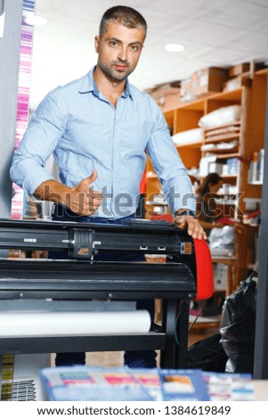 portrait of a working man at a printer studio