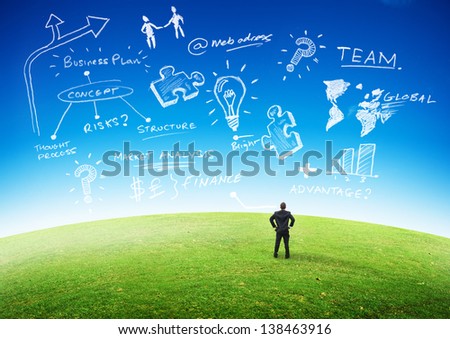Business Planning Concept, Businessman looking at plans in the sky.