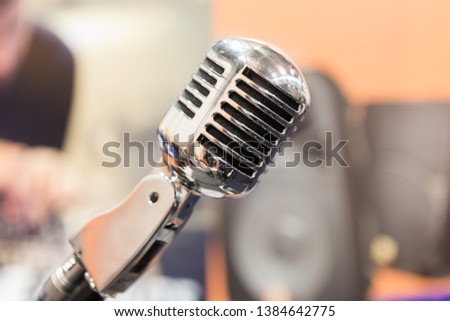 Steel covered microphone in recording studio.