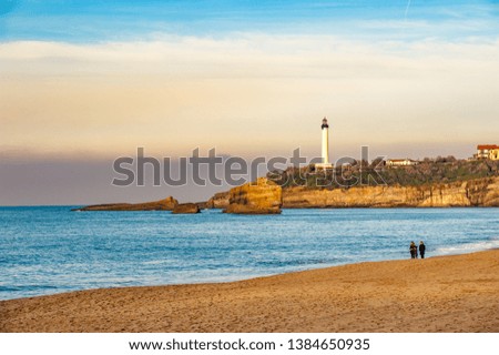 A view to Biarritz from the sea with rocks on a foreground