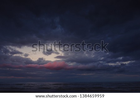 Cloudy sunset with blue and red clouds