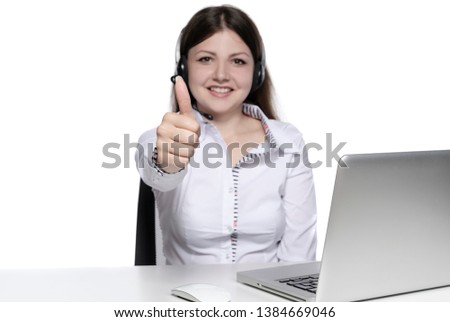 Young businesswoman, secretary or student working on her laptop and shown thumbs up, isolated on white background