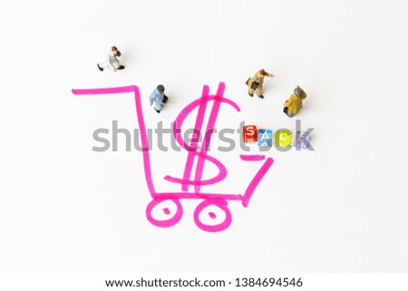 Miniature people on paper with painted shopping cart