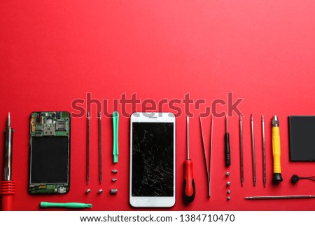 Broken mobile phone and repair tools on color background, flat lay. Space for text