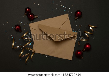 Craft envelopes decoration sparkles on a dark background with place for text. Top view, flat lay.