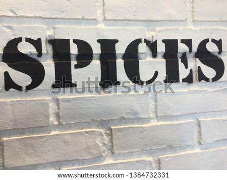 SPICES. Black Letters On The White Wall