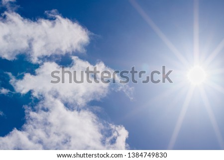 Sun shine on blue sky. White clouds with sunshine on blue sky. Shining sun at blue sky with lens flare, abstract background , copy space