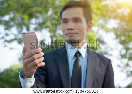 Businessman Holding Mobile Smart Phone and using Smart phone for Business connection 
