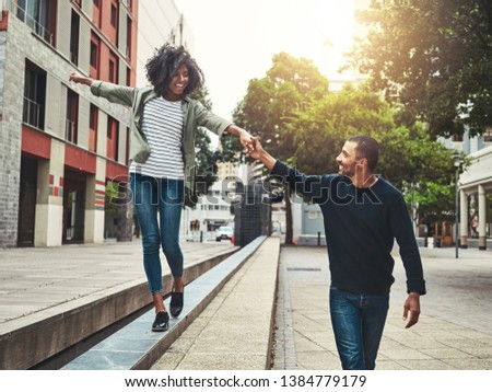 Cheerful couple enjoying walking in the city