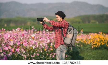 photographer taking photo of flowers mountain, landscape