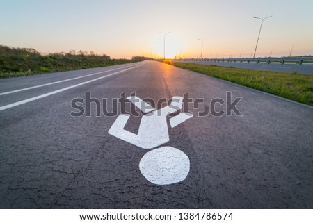 Pedestrian symbol on the path in the evening on the highway.