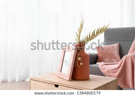 Wooden table with stylish decor in interior of room