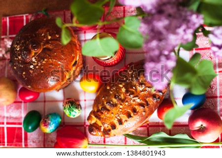Easter cakes and eggs with a lamp and flowers of lilac and tulip