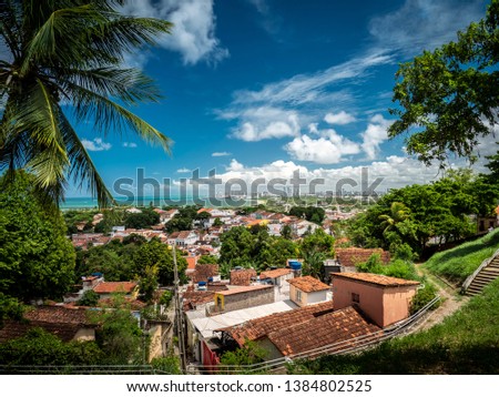 Aerial view of Olinda in Pernambuco, Brazil showcasing its historic buildings dated from the 17th century in the Atlantic Forest on a sunny day.