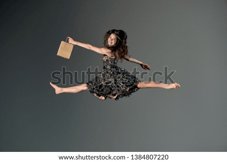 Girl in a dress in flight with shopping bag